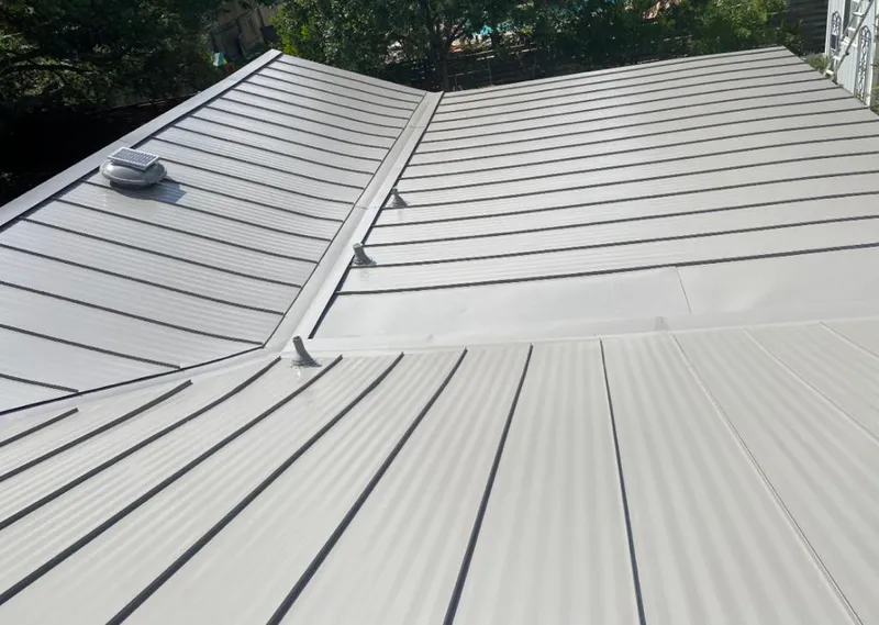 Solar attic fan installed on a metal roof for Roof Ventilation in Brook Park
