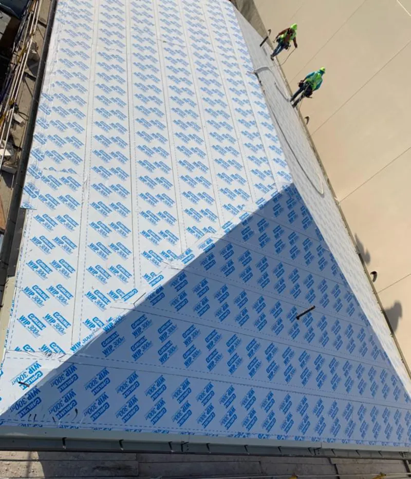 Professional roofers installing underlayment on a metal roof in Brook Park